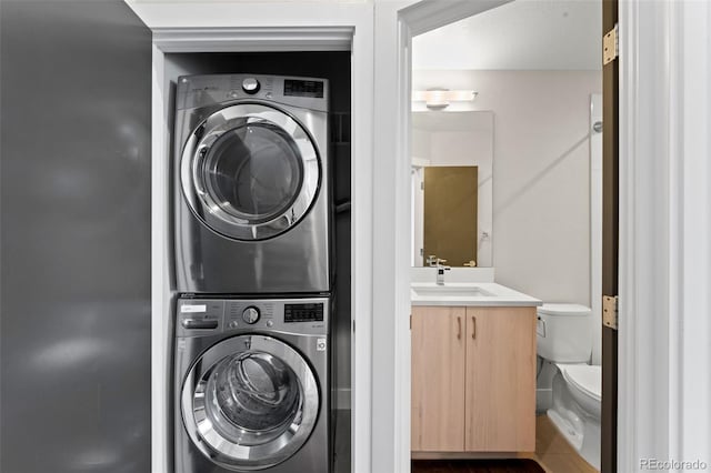 washroom featuring stacked washer / drying machine