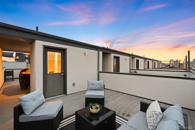 deck at dusk with outdoor lounge area
