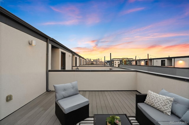 deck at dusk featuring an outdoor hangout area