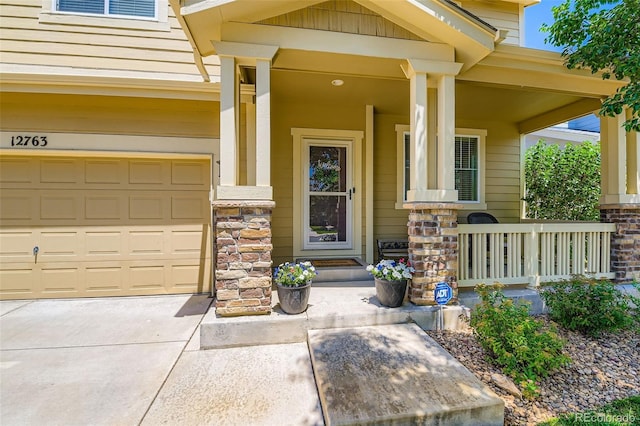 12763 E 105th Pl, Commerce City, CO 80022 - property entrance with covered porch, stone siding, an attached garage, and concrete driveway