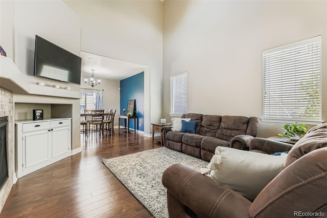 12763 E 105th Pl, Commerce City, CO 80022 - living room with a chandelier, dark wood-style flooring, and a towering ceiling
