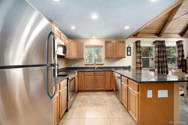 12569 S Parker Ave, Pine, CO 80470 - kitchen with appliances with stainless steel finishes, beam ceiling, a sink, light tile patterned floors, and a peninsula
