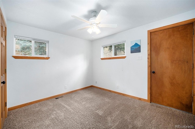 12569 S Parker Ave, Pine, CO 80470 - carpeted empty room with visible vents, baseboards, plenty of natural light, and ceiling fan