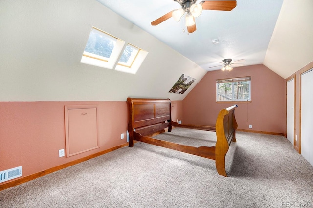 12569 S Parker Ave, Pine, CO 80470 - carpeted bedroom with a ceiling fan, baseboards, visible vents, and lofted ceiling with skylight