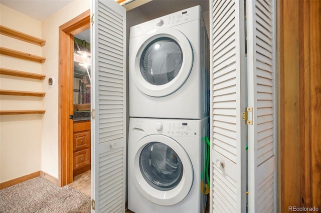 12569 S Parker Ave, Pine, CO 80470 - clothes washing area with carpet floors, stacked washer / drying machine, baseboards, and laundry area
