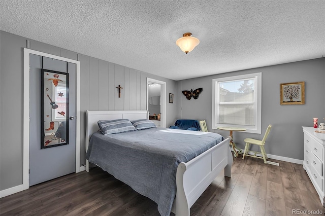 bedroom featuring dark hardwood / wood-style flooring and a textured ceiling