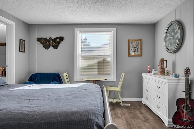 bedroom with dark wood-type flooring and a textured ceiling