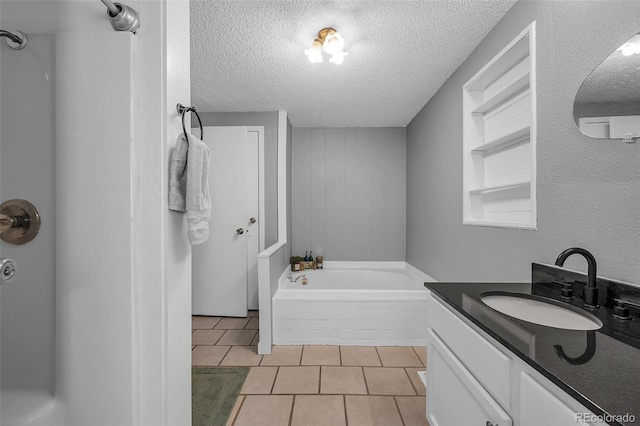 bathroom featuring a textured ceiling, vanity, and tile patterned flooring