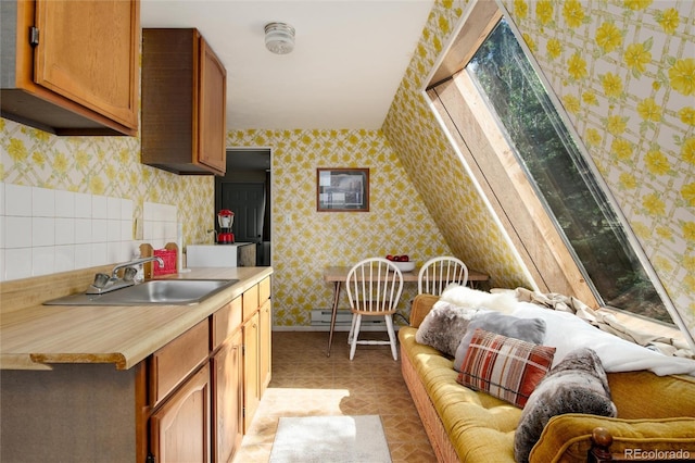 63 Welsh Cob Ln, Jefferson, CO 80456 - kitchen featuring wallpapered walls, light countertops, and brown cabinets