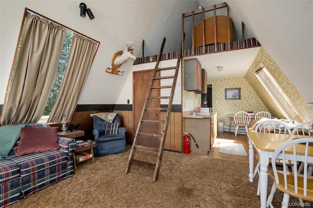 63 Welsh Cob Ln, Jefferson, CO 80456 - carpeted bedroom featuring a wainscoted wall, wood walls, and a towering ceiling