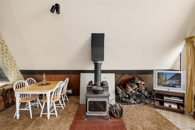 63 Welsh Cob Ln, Jefferson, CO 80456 - dining room with a wood stove, a wainscoted wall, and wooden walls