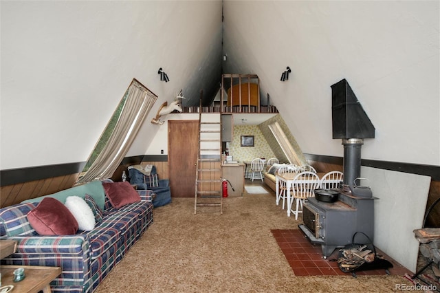 63 Welsh Cob Ln, Jefferson, CO 80456 - living area with wainscoting, carpet, a wood stove, and a towering ceiling