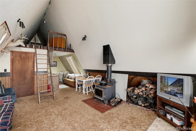 63 Welsh Cob Ln, Jefferson, CO 80456 - living room featuring a wood stove, wainscoting, carpet, and vaulted ceiling