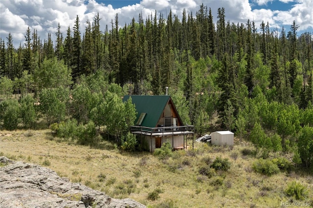 63 Welsh Cob Ln, Jefferson, CO 80456 - view of yard featuring a forest view and a storage unit