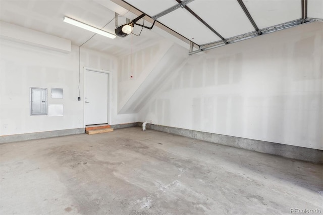 garage with a garage door opener and electric panel