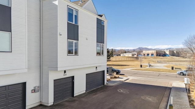 view of home's exterior with a garage and a mountain view