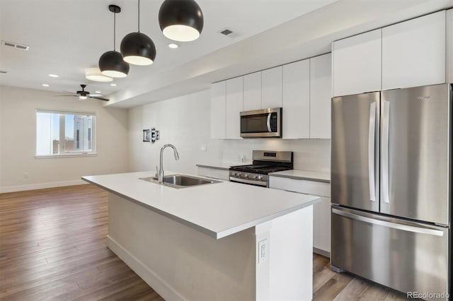 kitchen with light wood-style floors, visible vents, appliances with stainless steel finishes, and a sink