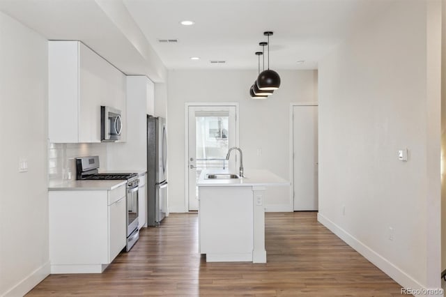 kitchen featuring a sink, visible vents, white cabinets, light countertops, and appliances with stainless steel finishes