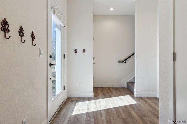 entrance foyer featuring stairs, wood finished floors, and baseboards