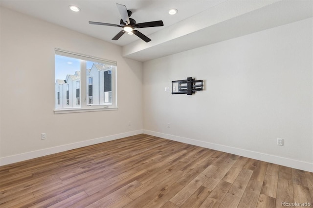 empty room with light wood-style floors, baseboards, and recessed lighting