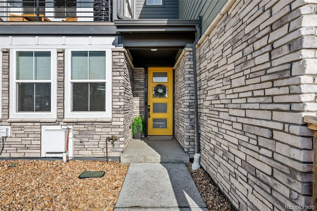 entrance to property featuring stone siding