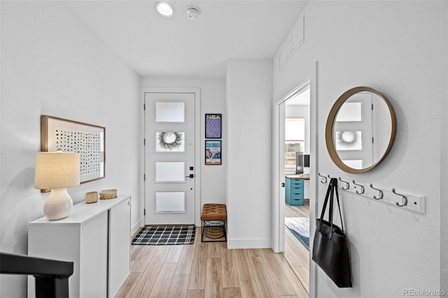 entryway featuring visible vents, baseboards, and light wood-type flooring