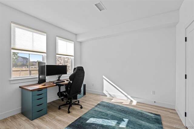 office space featuring visible vents, baseboards, and light wood-style floors