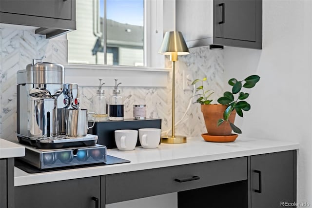 interior space with light countertops, decorative backsplash, and gray cabinetry
