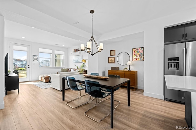 dining room featuring baseboards, light wood finished floors, a chandelier, and recessed lighting