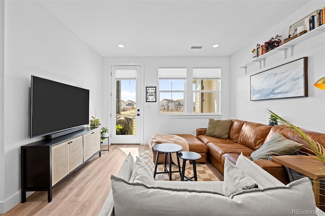 living area with recessed lighting, light wood-style flooring, baseboards, and visible vents