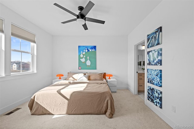 carpeted bedroom featuring visible vents, baseboards, connected bathroom, and ceiling fan