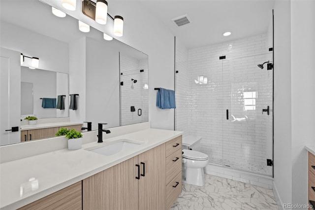 full bath with toilet, marble finish floor, vanity, and a stall shower