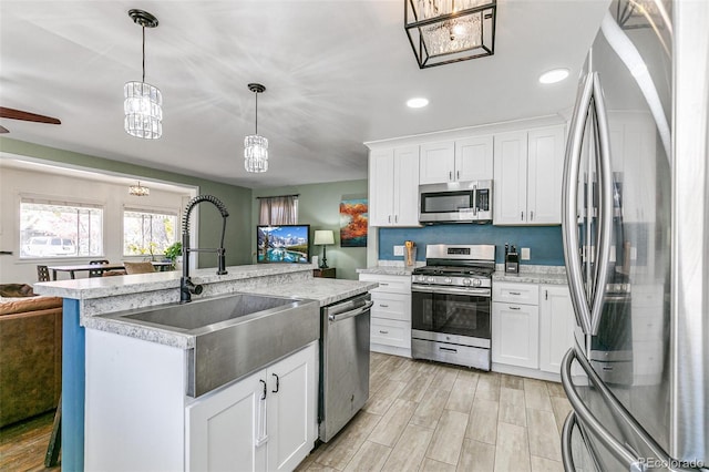 kitchen featuring stainless steel appliances, white cabinets, and sink