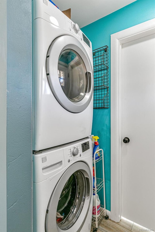 laundry area featuring stacked washing maching and dryer