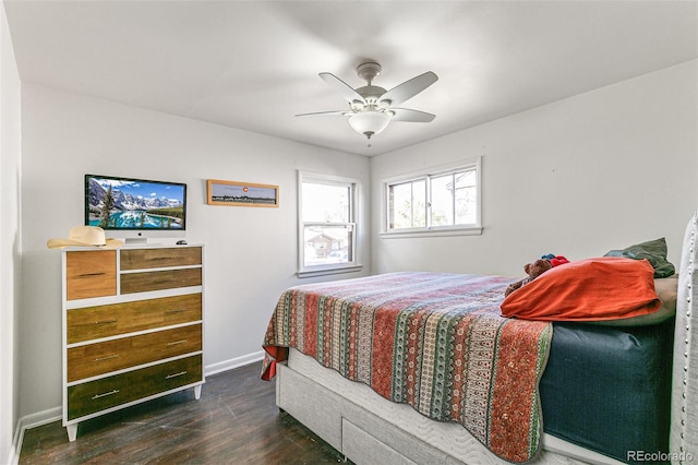 bedroom with dark hardwood / wood-style flooring and ceiling fan