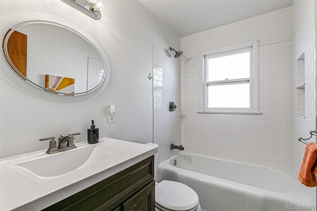 full bathroom with toilet, tiled shower / bath combo, and vanity