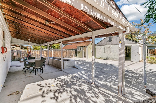 view of patio featuring a storage unit