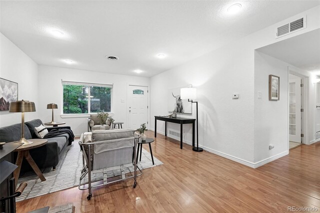 981 Ursula St, Aurora, CO 80011 - living room featuring light wood finished floors and baseboards