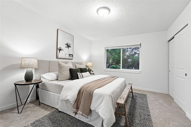 981 Ursula St, Aurora, CO 80011 - bedroom featuring light colored carpet, a textured ceiling, and baseboards