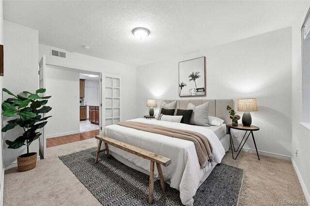 981 Ursula St, Aurora, CO 80011 - carpeted bedroom featuring a textured ceiling and baseboards
