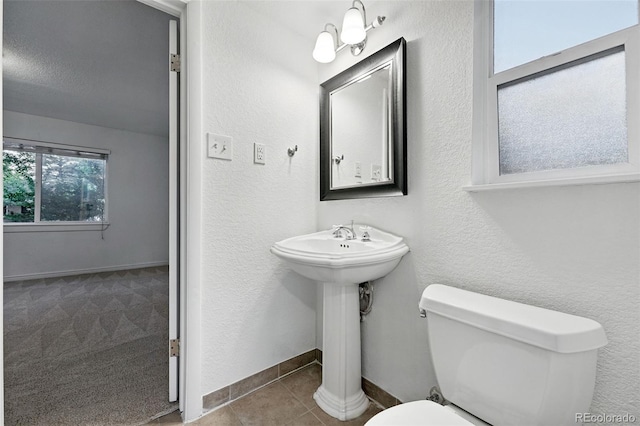 981 Ursula St, Aurora, CO 80011 - half bath featuring toilet, tile patterned flooring, and baseboards
