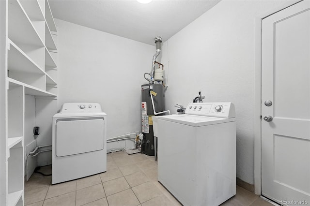 981 Ursula St, Aurora, CO 80011 - laundry room with washer and dryer, water heater, and light tile patterned flooring