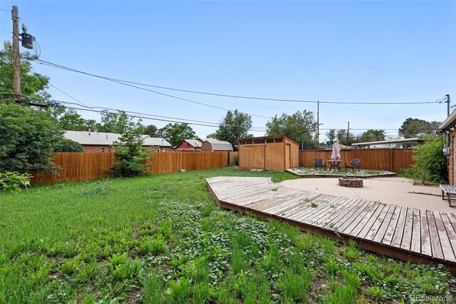 981 Ursula St, Aurora, CO 80011 - view of yard featuring a fire pit and a wooden deck