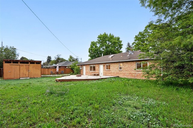 981 Ursula St, Aurora, CO 80011 - rear view of property featuring a wooden deck and brick siding