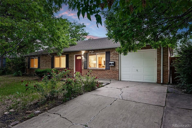 981 Ursula St, Aurora, CO 80011 - single story home featuring a garage, brick siding, and concrete driveway
