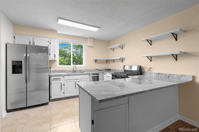 600 Bronco Rd, Denver, CO 80221 - kitchen featuring open shelves, stainless steel appliances, a peninsula, white cabinets, and a textured ceiling