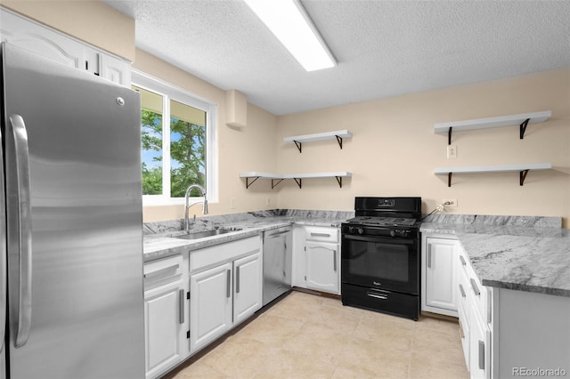 600 Bronco Rd, Denver, CO 80221 - kitchen featuring appliances with stainless steel finishes, open shelves, white cabinets, a textured ceiling, and light stone counters