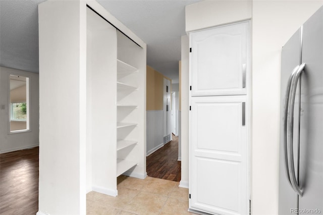 600 Bronco Rd, Denver, CO 80221 - corridor with baseboards and light tile patterned floors