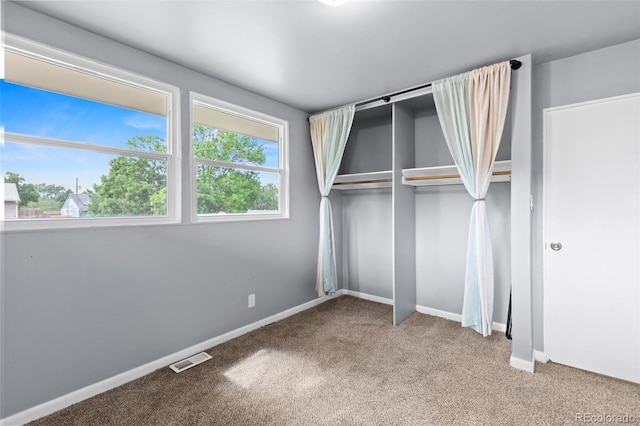 600 Bronco Rd, Denver, CO 80221 - unfurnished bedroom featuring carpet, multiple windows, and a closet