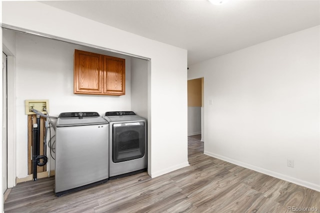 600 Bronco Rd, Denver, CO 80221 - washroom featuring light wood-style floors and washer and clothes dryer